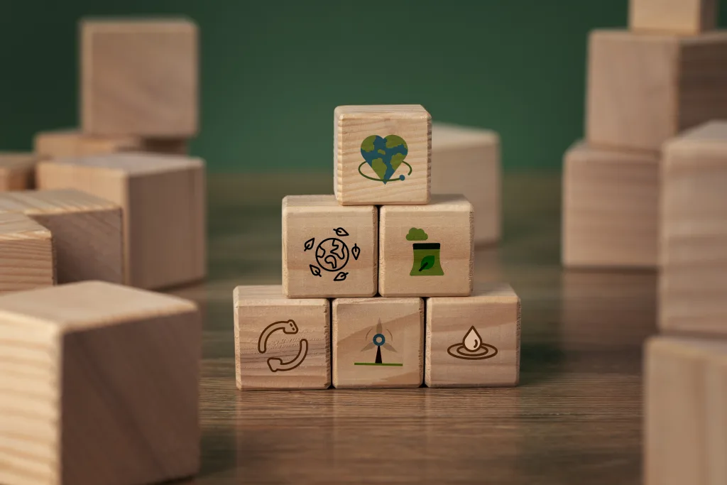 ESG sustainability concept with wooden blocks showing environmental services icons for waste management, recycling and green energy