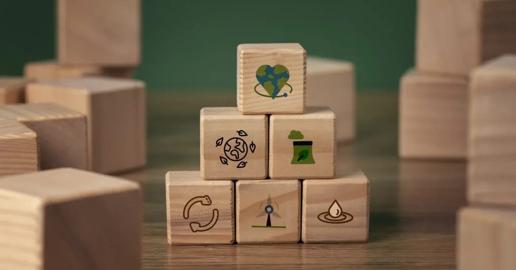 ESG sustainability concept with wooden blocks showing environmental services icons for waste management, recycling and green energy