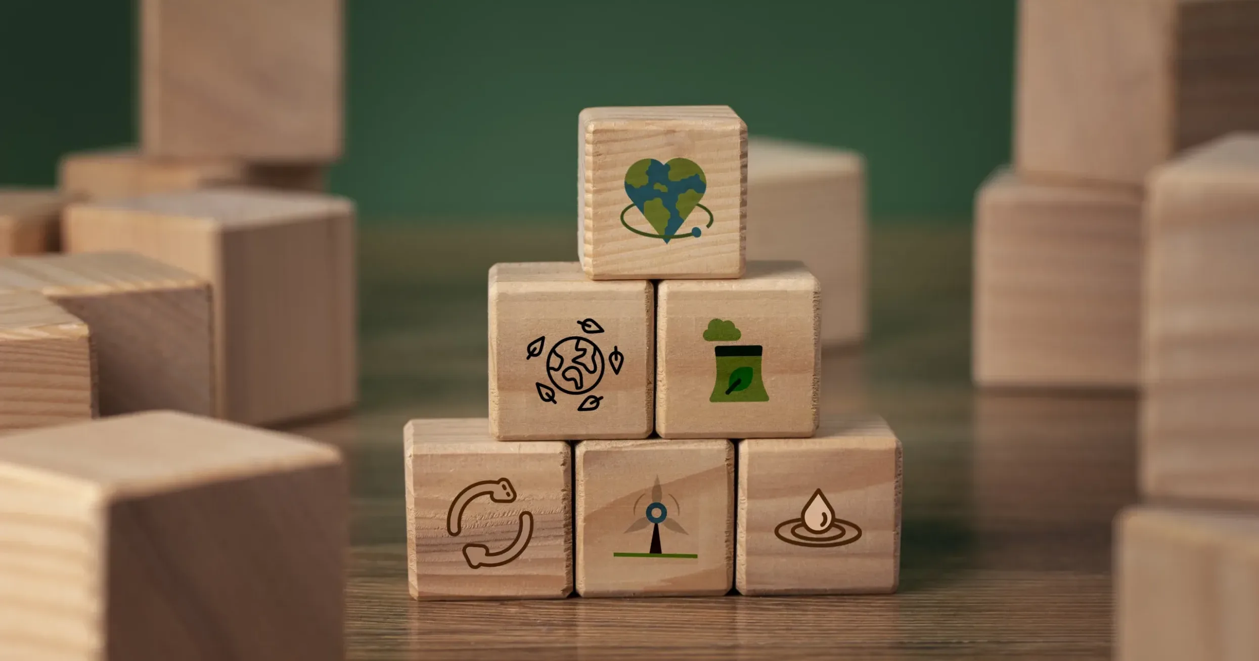 ESG sustainability concept with wooden blocks showing environmental services icons for waste management, recycling and green energy